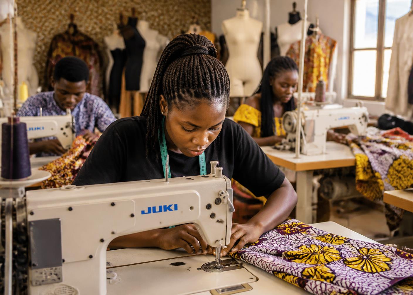 Students sewing African wax print fabric in the Abbi College atelier