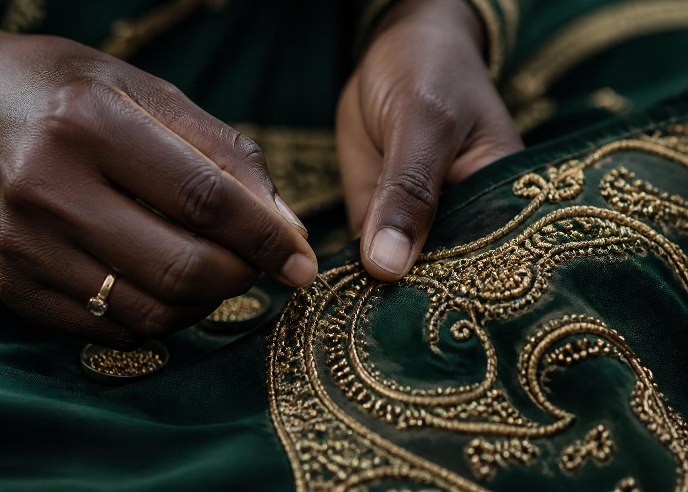 Gold thread embroidery on deep green fabric
